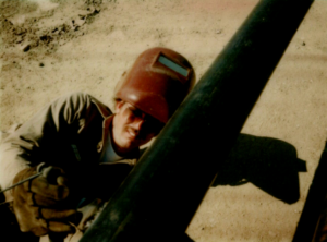 Ernie Gibson welding out in the field in the 80s
